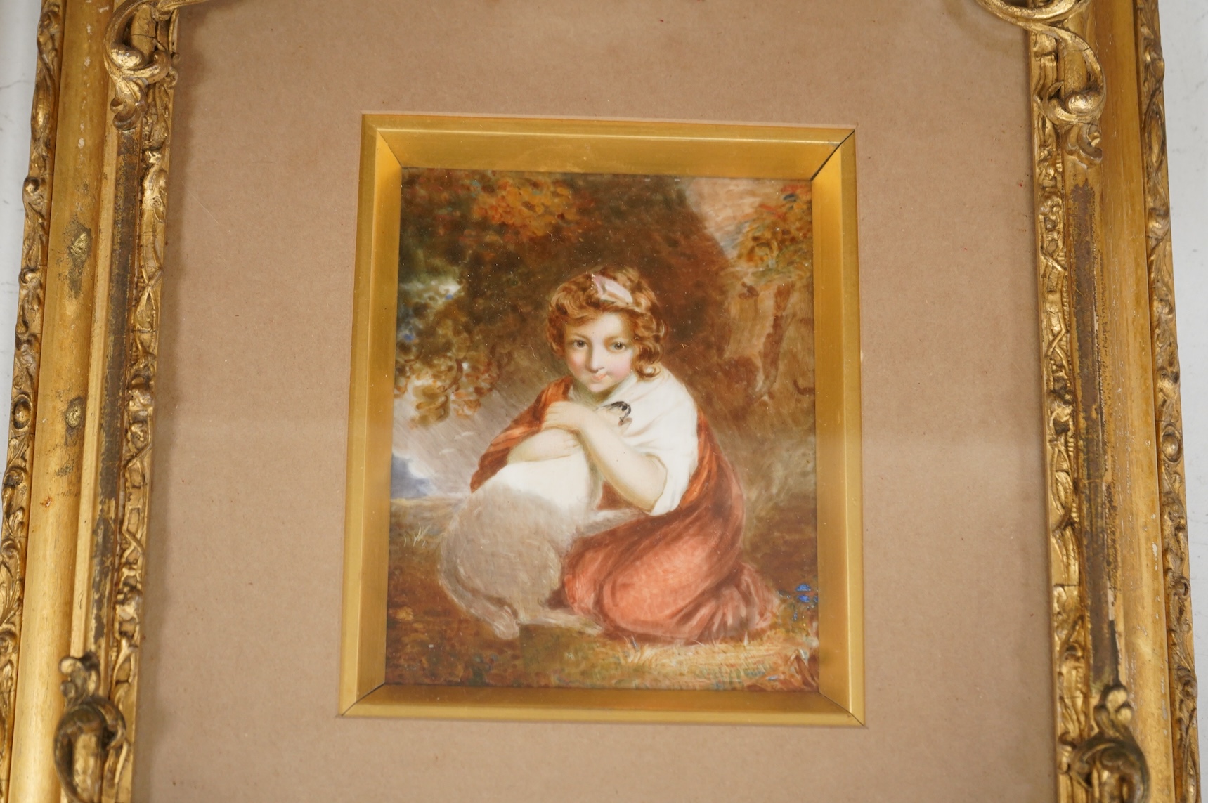 A Continental painted porcelain plaque of Saskia van Uylenburgh, after Rembrandt, together with another plaque of a young girl and her dog, after John Russell (2), Largest 17cm wide x 24cm high.